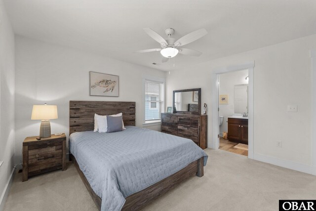 1207 Tail Wind Ct Lot 267, Corolla, NC 27927 - bedroom with light colored carpet, baseboards, and connected bathroom