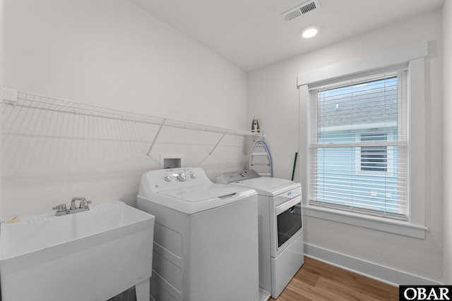 1207 Tail Wind Ct Lot 267, Corolla, NC 27927 - laundry area featuring washing machine and dryer, baseboards, healthy amount of natural light, and light wood-style floors