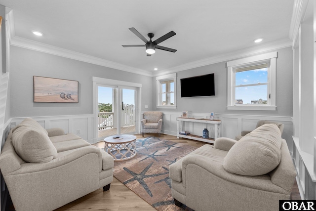 1207 Tail Wind Ct Lot 267, Corolla, NC 27927 - living room featuring wood finished floors, ceiling fan, crown molding, a wainscoted wall, and a decorative wall