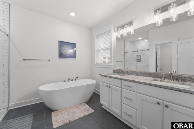 1207 Tail Wind Ct Lot 267, Corolla, NC 27927 - full bath featuring a shower stall, double vanity, a soaking tub, baseboards, and tile patterned floors