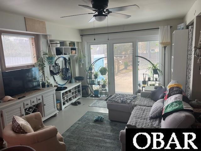 living room featuring concrete floors and a ceiling fan