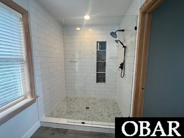 bathroom featuring tiled shower