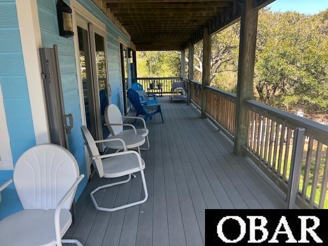 wooden terrace featuring covered porch