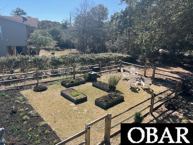 view of yard featuring a vegetable garden and fence