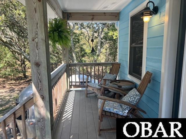 wooden terrace featuring covered porch