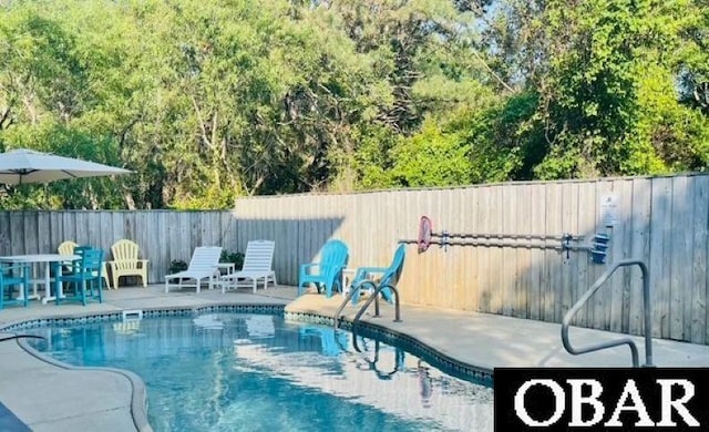 view of swimming pool with a fenced in pool, a fenced backyard, and a patio area