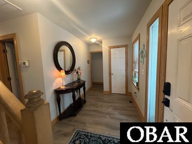 entrance foyer featuring visible vents, light wood-style flooring, and baseboards