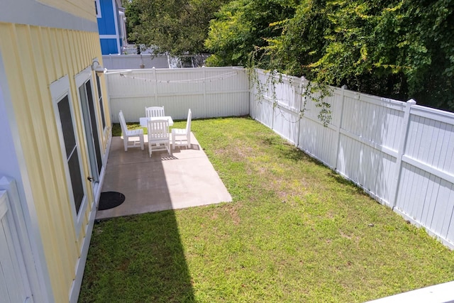 view of yard featuring a patio area and a fenced backyard