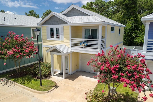 view of front of property featuring concrete driveway, fence, and a garage