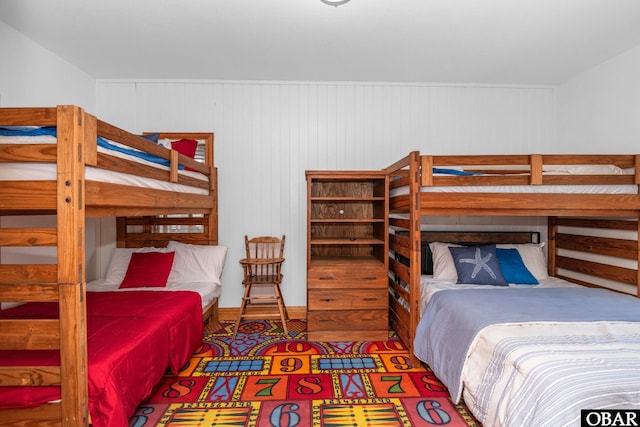 bedroom with wood walls