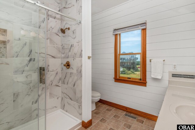 bathroom with wooden walls, a stall shower, toilet, and stone finish floor