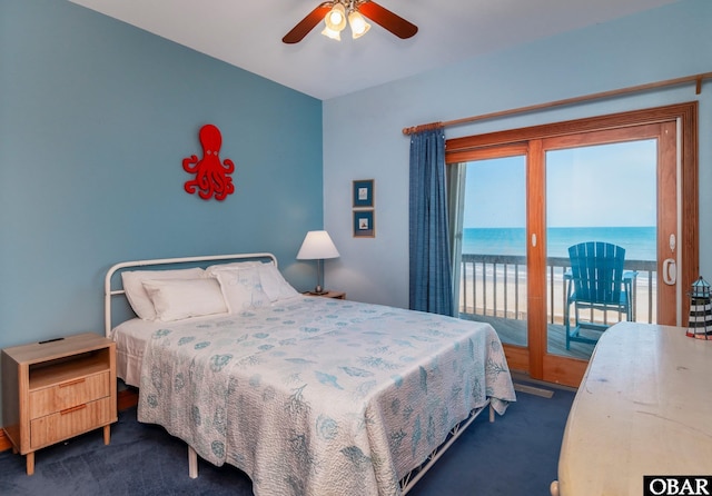 bedroom featuring dark carpet, a water view, a ceiling fan, and access to outside