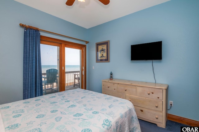 bedroom with dark colored carpet, a ceiling fan, and access to outside