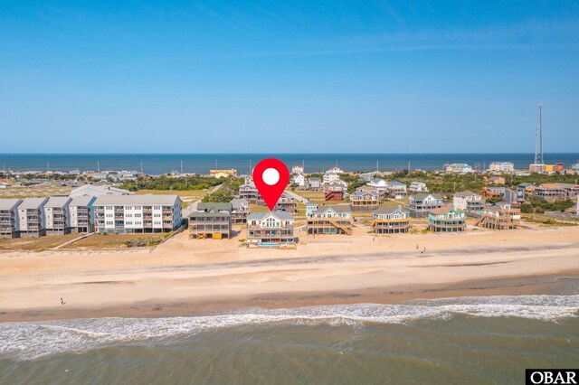 drone / aerial view featuring a water view and a view of the beach