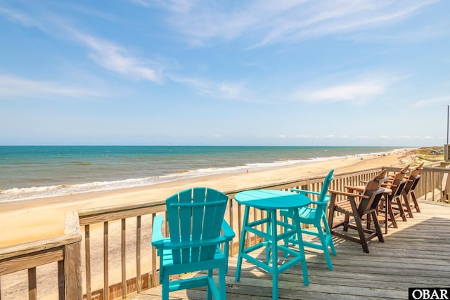 wooden terrace with a beach view and a water view