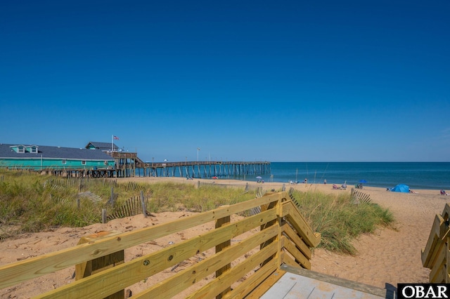 view of water feature with a pier and a view of the beach