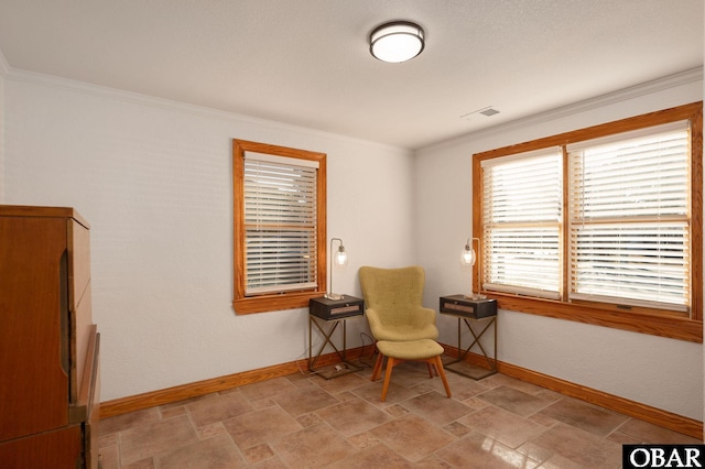 living area with crown molding, stone finish floor, visible vents, and baseboards