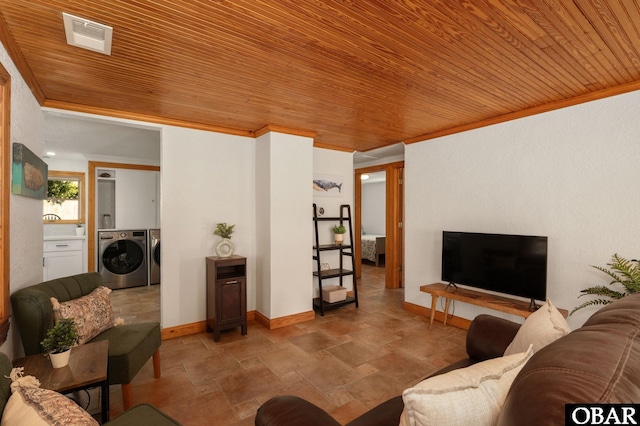 living area with wood ceiling, washing machine and dryer, visible vents, and crown molding