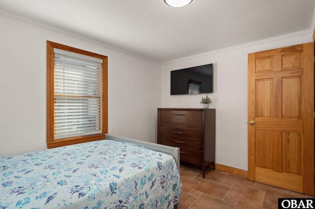 bedroom with stone finish floor, crown molding, and baseboards