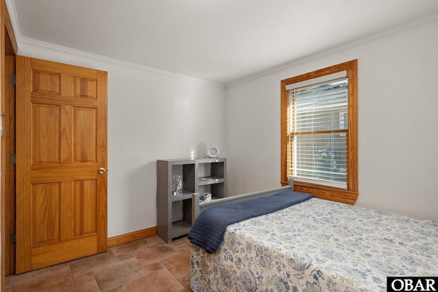 bedroom with stone finish flooring, crown molding, and baseboards