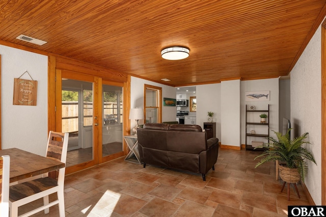 living room with visible vents, stone finish flooring, wood ceiling, and crown molding