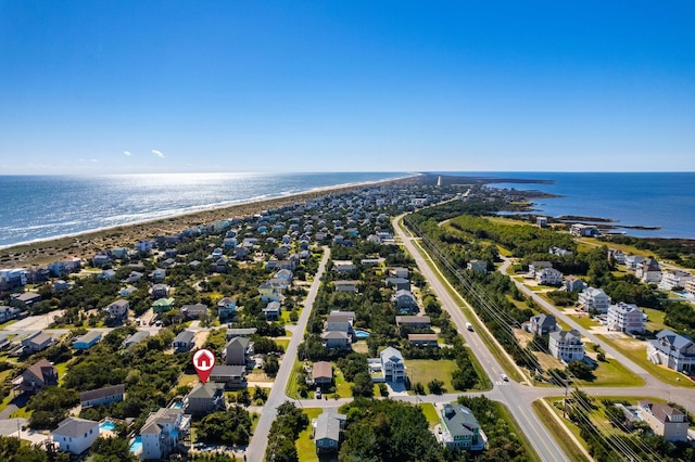 drone / aerial view with a water view, a residential view, and a view of the beach