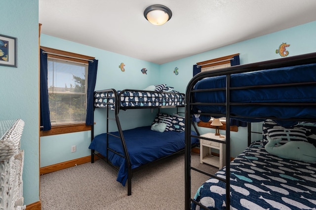 carpeted bedroom featuring baseboards