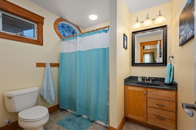 bathroom featuring tile patterned flooring, toilet, vanity, baseboards, and shower / bathtub combination with curtain