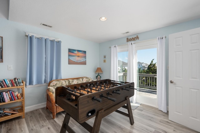 recreation room featuring light wood-type flooring, baseboards, visible vents, and recessed lighting