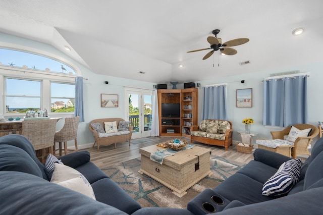 living room with light wood-style flooring, visible vents, vaulted ceiling, and recessed lighting