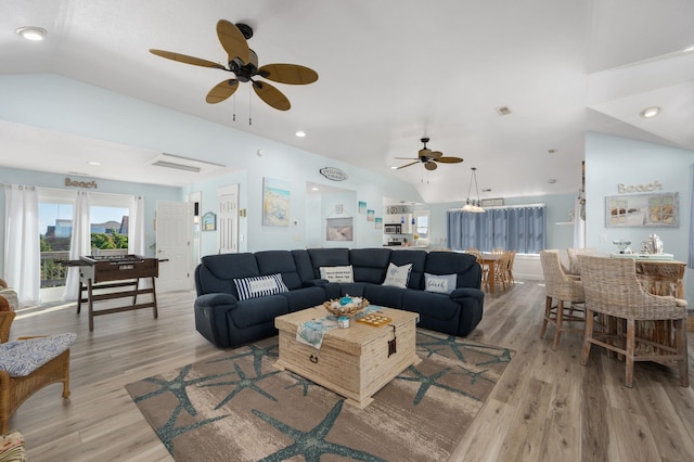 living area featuring lofted ceiling, light wood-type flooring, a ceiling fan, and recessed lighting