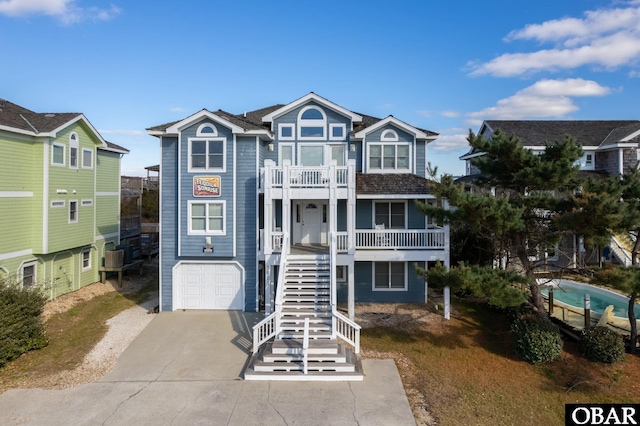 5001 S Virginia Dare Trl Lot 25, Nags Head, NC 27959 - coastal inspired home with stairway, a balcony, a garage, driveway, and a porch