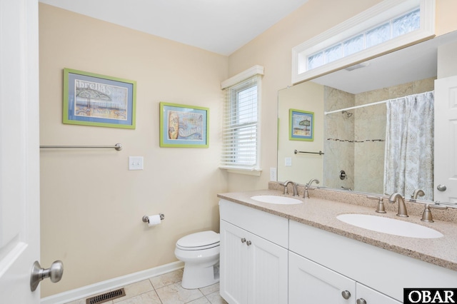 5001 S Virginia Dare Trl Lot 25, Nags Head, NC 27959 - full bathroom featuring toilet, double vanity, baseboards, and a shower with curtain