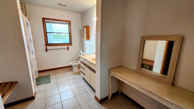 full bath with baseboards, visible vents, toilet, tile patterned floors, and vanity