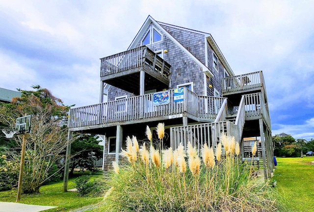 rear view of house with stairs and a wooden deck