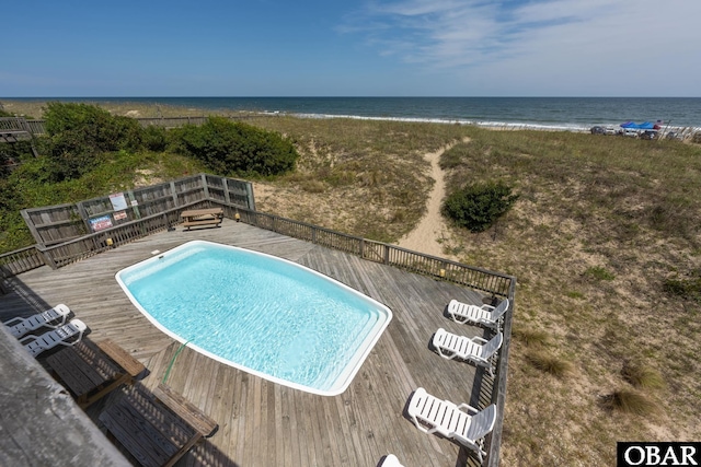 view of swimming pool with a deck with water view and a fenced in pool