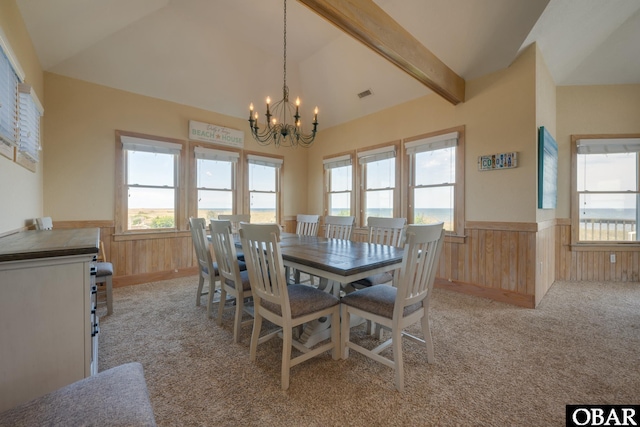 dining room with plenty of natural light, wainscoting, and an inviting chandelier