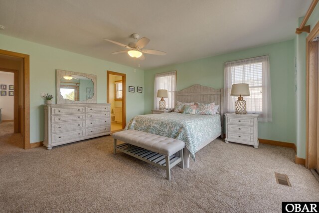 bedroom with visible vents, multiple windows, light carpet, and baseboards