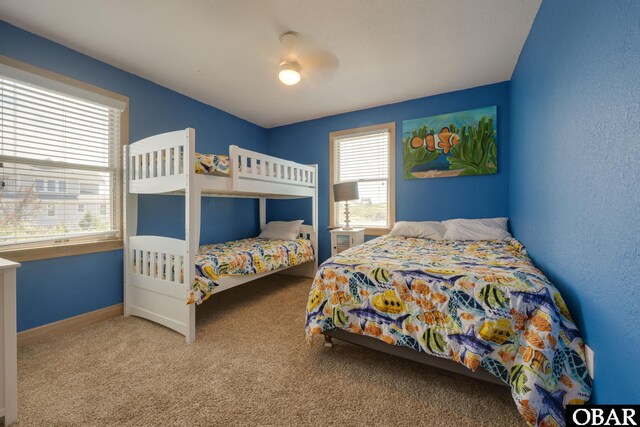 carpeted bedroom featuring ceiling fan and baseboards