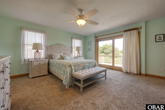 bedroom with baseboards, access to outside, multiple windows, and light colored carpet