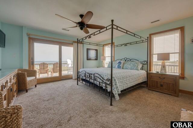 bedroom featuring access to exterior, visible vents, carpet floors, and multiple windows