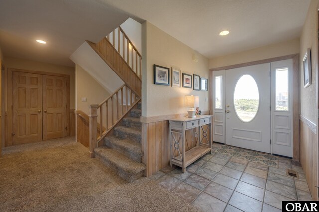 entryway with visible vents, stairway, light colored carpet, and recessed lighting