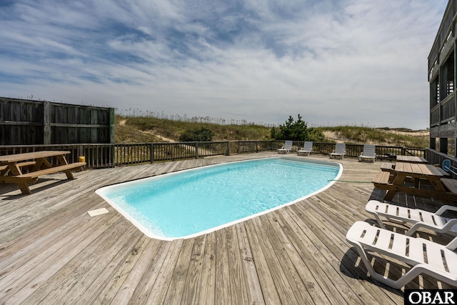 view of pool with a fenced in pool and a wooden deck