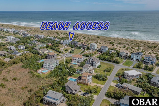 bird's eye view with a water view, a residential view, and a beach view