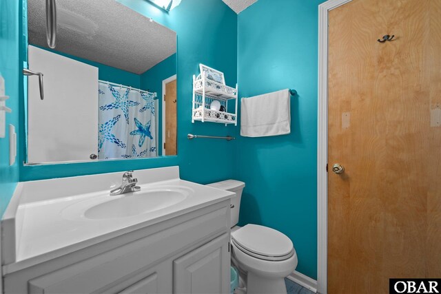 bathroom with toilet, a textured ceiling, and vanity