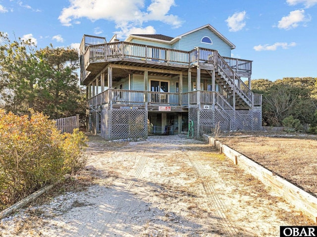 view of front of house with stairway and a wooden deck