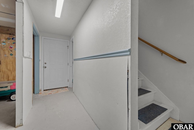 staircase with concrete flooring