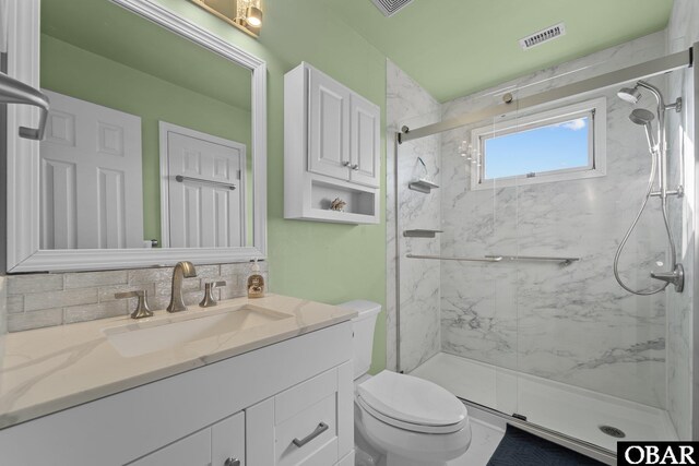 1620 Sandpiper Rd Lot 2, Corolla, NC 27927 - bathroom featuring a marble finish shower, visible vents, vanity, and toilet