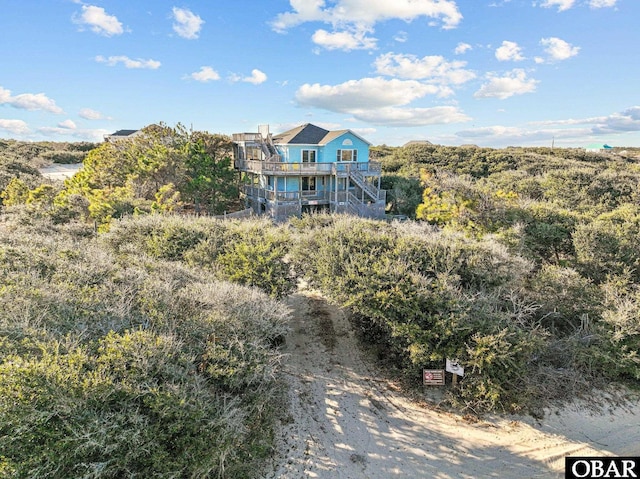 view of front of property with stairs and a wooden deck