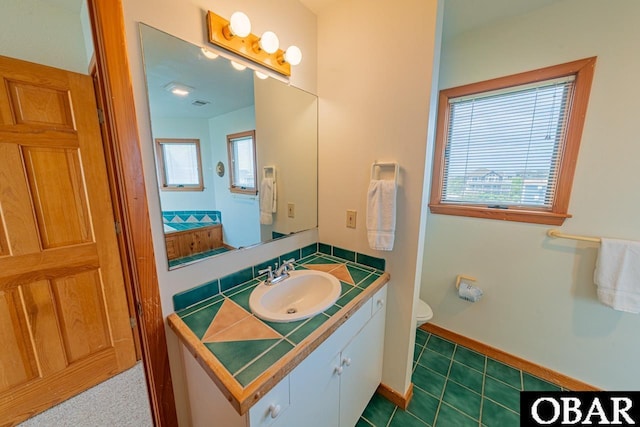 bathroom featuring visible vents, tile patterned floors, vanity, and toilet